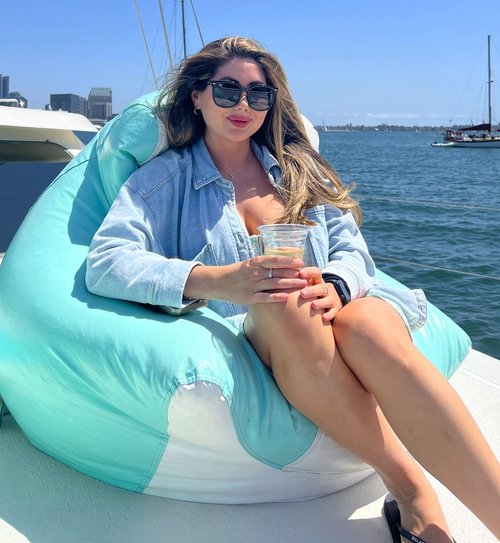 Guest relaxing on a bean bag aboard the catamaran
