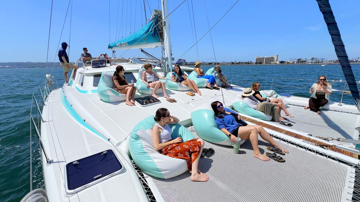 Group relaxing on a Malarky catamaran in San Diego Bay