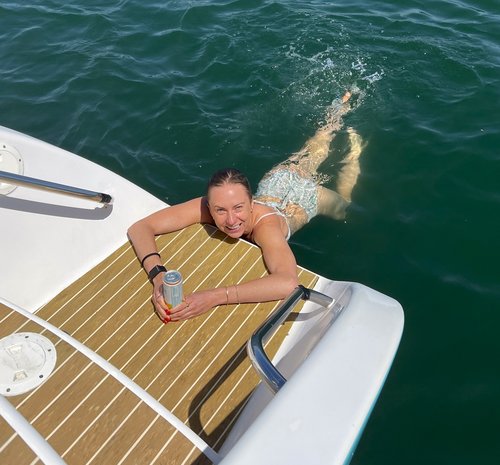 Guest swimming from the Malarky catamaran swim platform
